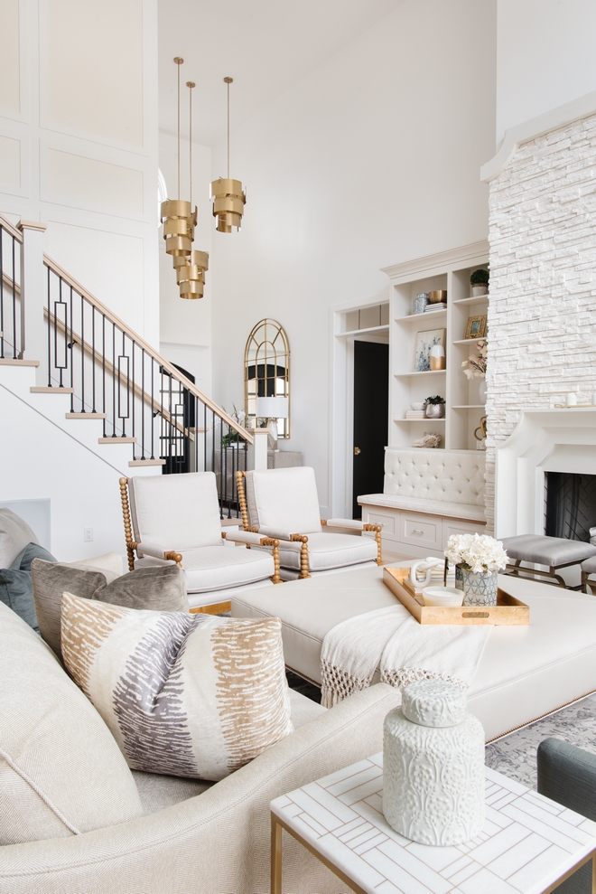 Neutral Interior Two-story ceiling Great Room with Neutral Decor Foyer opens into an elegant Great Room with a soaring double-height ceiling and a stunning stone fireplace #NeutralInterior #Twostoryceiling #GreatRoom #NeutralDecor #Foyer #elegantinteriors #soaringdoubleheightceiling #doubleheightceiling #stonefireplace