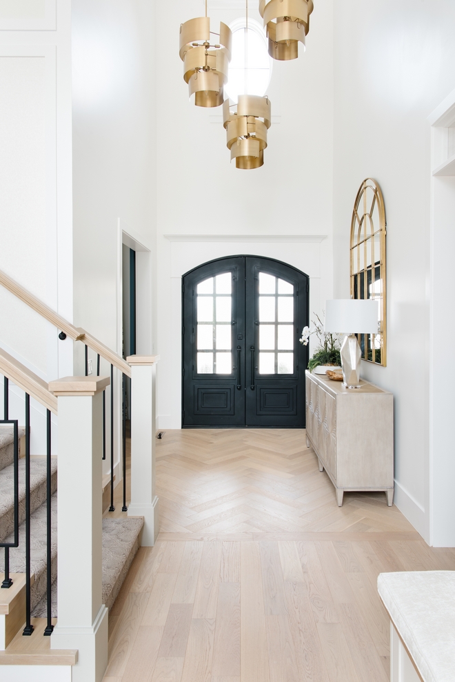 Foyer The Foyer features Iron front doors herringbone entry wood floor and an amazing grouping of pendants If you look closely you’ll get a better view of the gorgeous arched gold mirror entry console and so much texture Foyer The Foyer features Iron front doors herringbone entry wood floor and an amazing grouping of pendants If you look closely you’ll get a better view of the gorgeous arched gold mirror entry console and so much texture #Foyer #Ironfrontdoor #Ironfrontdoor #herringbone #entry #woodfloor #herringbonewoodfloor #pendants #archedmirror #goldmirror #entry #consoletable #texture