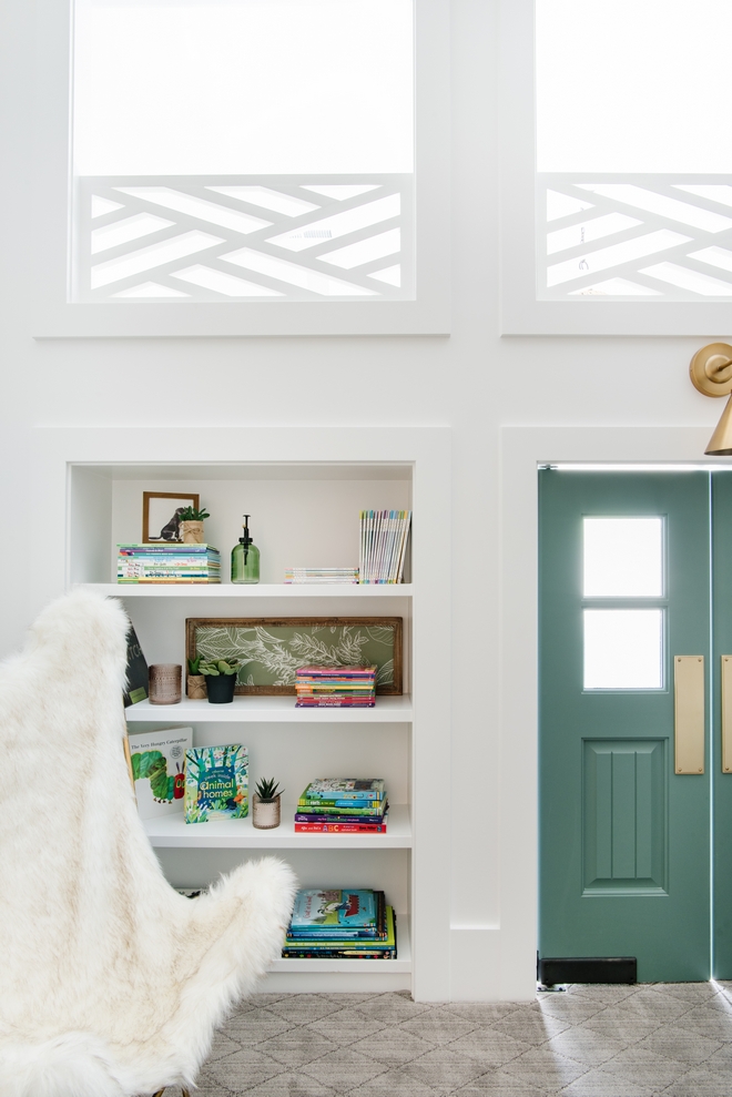 Custom bookcases flank the swinging doors and are at the children's reach #bookcase #playroom #interiordesigner #interiordesign #interiordesignideas