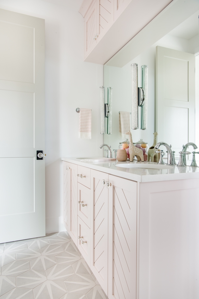 Girl Bathroom Design The Chevron pattern on the doors the lucite and gold cabinet hardware the crystal door knobs the additional necessary storage above the vanity and then the Bedrosians Floor tile #bathroom #girlbathroomdesign #interiordesigner #interiordesign #interiordesignideas