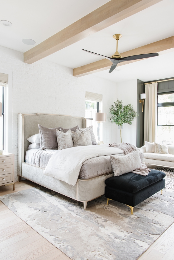 Layered bedroom This bedroom has wood floors dark vertical shiplap painted brick animal hide rug velvet drapes fur pillows #Layeredbedroom #bedroom #woodfloors #verticalshiplap #paintedbrick #animalhiderug #velvetdrapes #furpillows