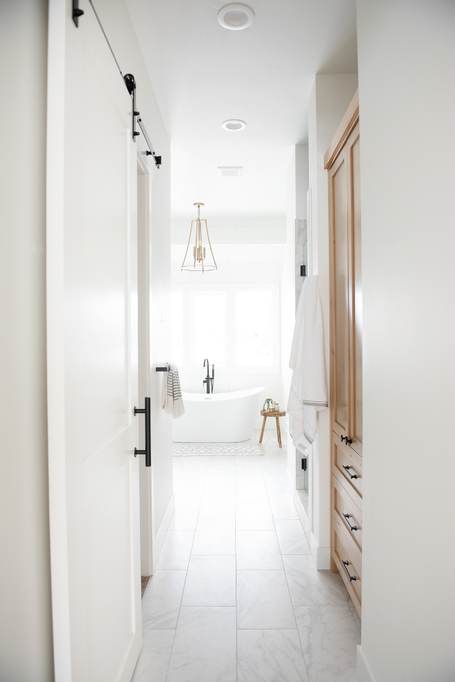 What an inspiring layout The Master Bathroom features custom linen cabinetry while a custom barn door conceals the Walk-in Closet Also notice the shower on the far right #Bathroomlayout #Bathroom #MasterBathroom #linencabinetry #barndoor #WalkinCloset