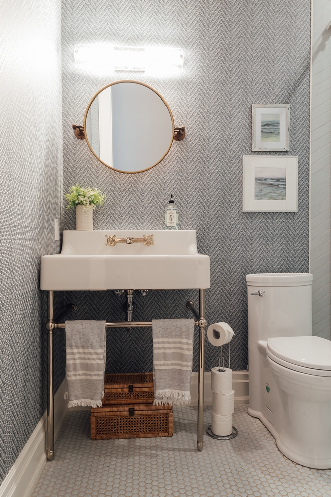 Powder Room located off of the Mudroom hallway is a small space packed with style and interior detailing from the ceiling detail wallpaper and plumbing fixtures #bathroom