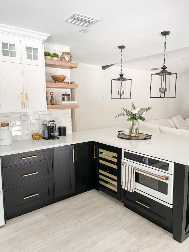 Black and white kitchen Black lower cabinets with white upper cabinets and open shelves over white subway tile backsplash Black and white kitchen Black lower cabinets with white upper cabinets and open shelves over white subway tile backsplash Black and white kitchen Black lower cabinets with white upper cabinets and open shelves over white subway tile backsplash #Blackandwhitekitchen #Blackandwhite #kitchen #Blacklowercabinets #whiteuppercabinets #openshelves #whitesubwaytile #backsplash