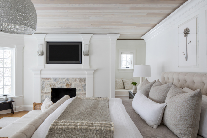 The designer added natural stone to the fireplace surround to provide a more organic environment #designer #bedroom #organicinteriors