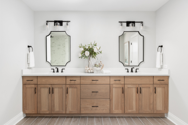 The ensuite bathroom is spa-inspired with custom cabinetry distinctive lighting selections and stone tile accented walls