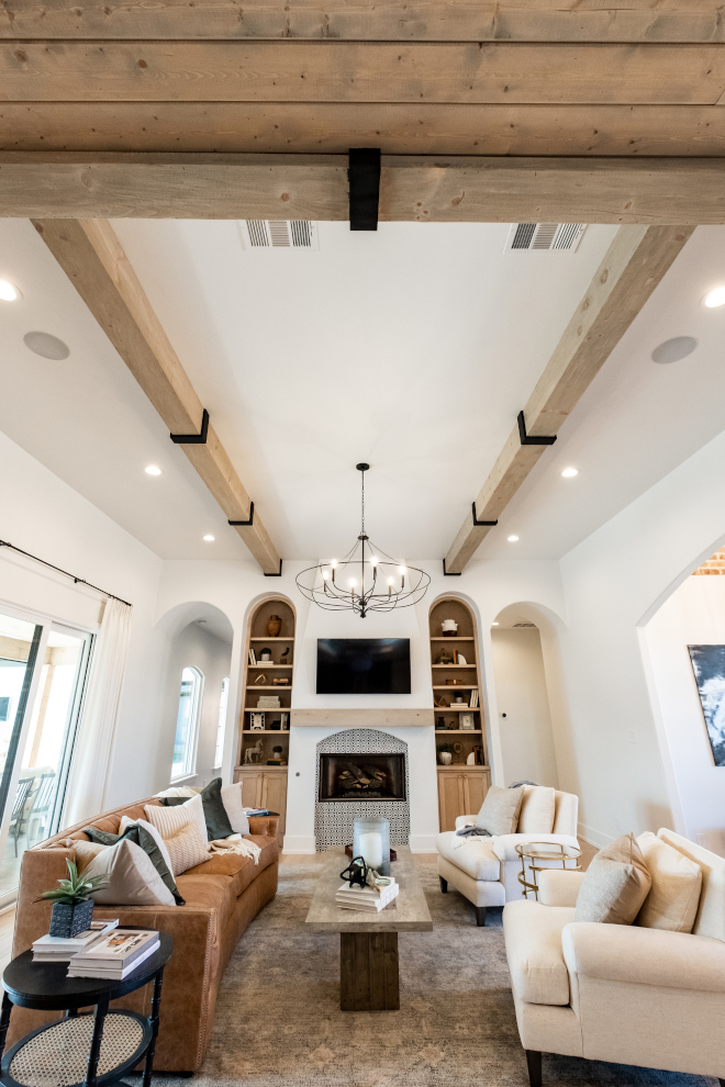 We used custom made faux wood beams made to frame in the light fixture and directionally point our design to the custom made inset bookshelves that sit inside the wall #beams #ceiling #livingroom
