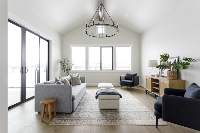 The black windows and sliding doors are really the main event here so I just topped it off with a classic chandelier in matte black #familyroom #livingroom #blackdoors #blackwindows