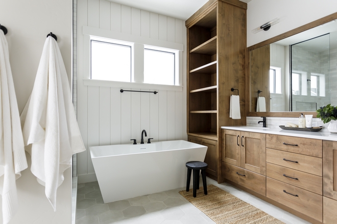 In the primary suite I wanted to continue layering in the wainscot to feel thoughtful and finished I especially love this element behind the freestanding tub in the bathroom