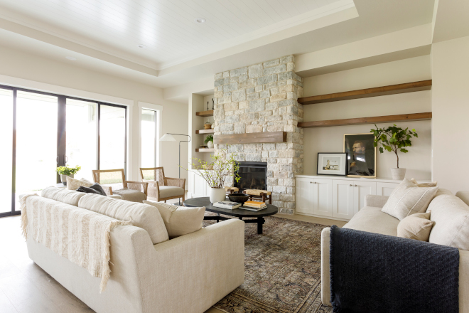 One of my very favorite manufactured stones is installed on the fireplace in the living room and the tones really bring the entire kitchen living area together #livingroom #stonefireplace #fireplace #AmberLewis #interiordesign #homedecor #coffeetable
