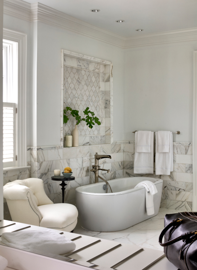 Surrounded by Calacatta marble this serene suite bathroom features a free-standing tub and double vanity #bathroom #calacattamarble #marble