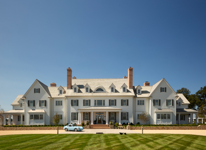  The home’s front elevation features a traditional exterior with front porch columns symmetrical windows and rooflines and curved eyebrow dormers #home #frontelevation #traditionalexterior #frontporch #porchcolumns #symmetricalwindows #rooflines #curvedwindow #eyebrowdormers