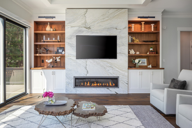 This marble fireplace with built-in shelves adds the perfect focal point in a living room #marblefireplace