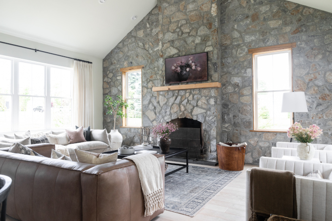 Great Room is located just across from the Kitchen and it features a stone accent wall and fireplace #GreatRoom #stonewall #accentwall
