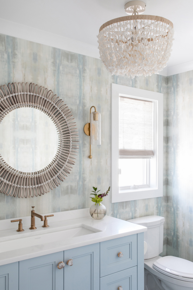 Metal accents and a textured mirror serve as the statement pieces for this bathroom Relaxing touches give the space a vacation-like feel #bathroom