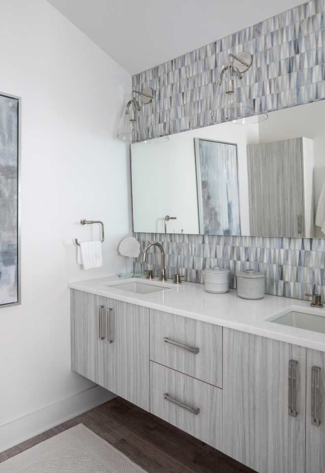 The Primary Bathroom features a veneered floating vanity with large pulls and a stunning accent wall tile #bathroom #masterbathroom