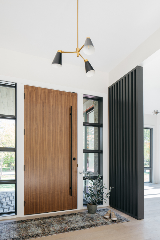 A custom vertical partition adds architectural interest to the Foyer and creates a sense of separation from the Dining Room #verticalpartition #partition #Louver