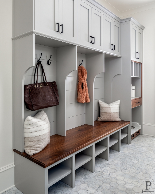 Not your average Mudroom featuring all the necessaries such as coat hooks Walnut top bench seating built-in shoe racks mail holders and of course don’t miss the pet-friendly dog bowl and with a pot filler #mudroom #pet #dogbowl #mudroomdesign