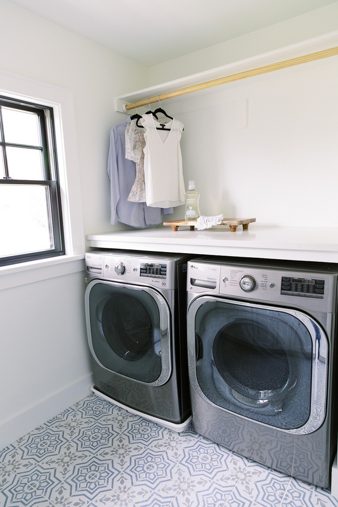 In the laundry room we used a playful patterned porcelain floor tile added plenty of cabinets for storage and choose a high-capacity washer and dryer #washer #dryer #laundryroom