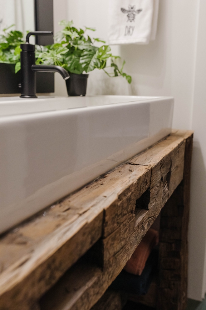 My husband used leftover reclaimed beams from the primary bedroom ceiling project to create a vanity base that would hold the trough sink He was done with the vanity in less than an hour #reclaimedwood #diy #sink #bathroom #vanity