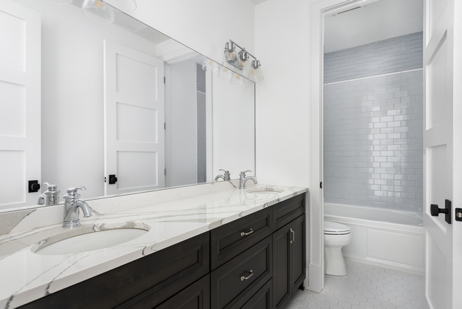 Jack & Jill Bathroom features a neutral color scheme Countertop is Cambria Brittanicca