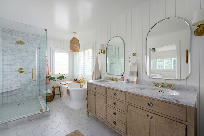 Organic and natural elements like marble wood and rattan make this bathroom feel classic and timeless. The brass fixtures and accents add a touch of modern glam while maintaining a vintage appeal #bathroom