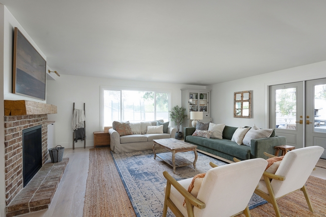 A thoughtful furniture layout and design along with layers of texture and warmth make this large space still feel cozy and inviting