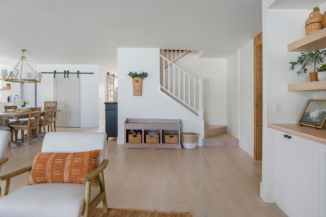 I am loving the idea of adding a storage bench with baskets by the staircase If you live in a two-story home you know how easily things can get collected by the stairs as the day goes by