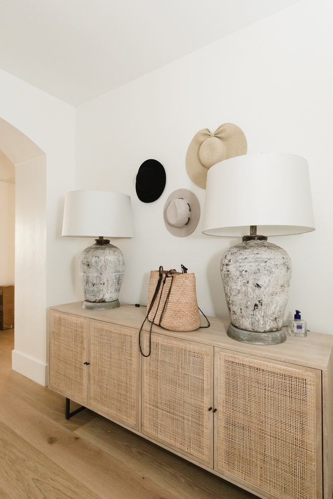 Neutral foyer with cane sideboard Neutral foyer with cane sideboard hats used as decor Neutral foyer with cane sideboard ideas Neutral foyer with cane sideboard #Neutralinteriors #neutrals #foyer #canesideboard