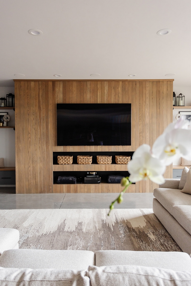 Great alternative for living spaces without a fireplace The Basement features a White Oak paneling with custom niches that mimics a fireplace What an inspiring design