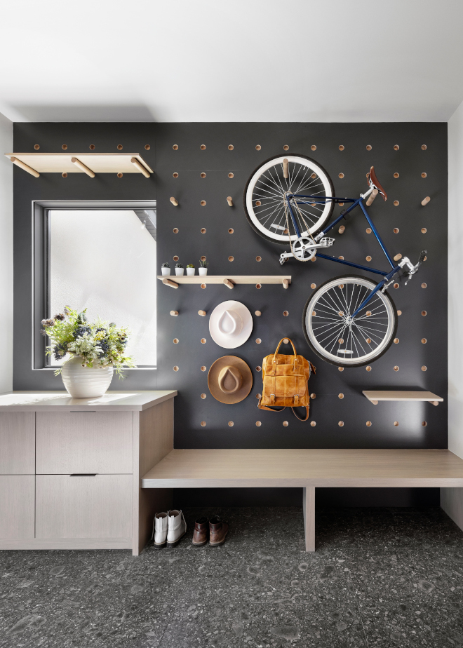 A Peg Board paneling creates adjustable storage in this fun Mudroom How ingenious #Mudroom