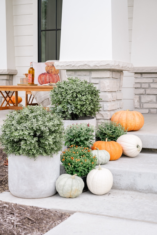 Pumpkins along with mums one of fall's quintessential flowers bring the Autumn right at this home's front porch #Fall #mums #pumpkins #flowers #Autumn #Falldecor #frontporch