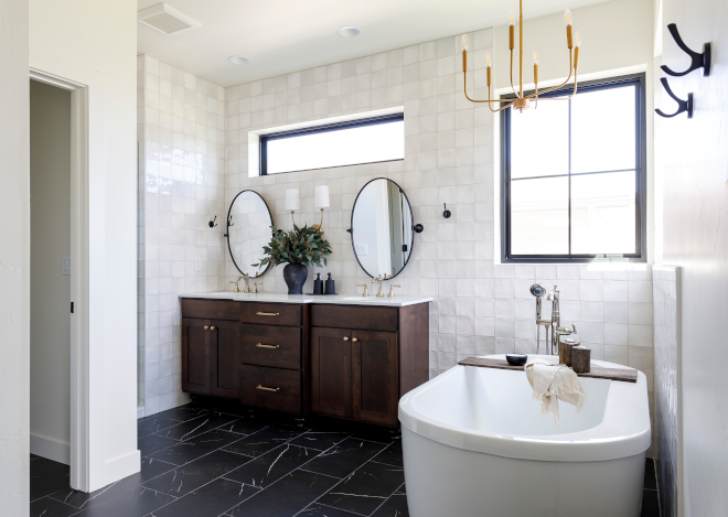 Bathroom The dark tile grounds the space while the square wall tiles add movement and interest