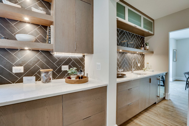 Butler's Pantry features slab White Oak cabinets and the same striking herringbone backsplash tile #Butlerspantry #whiteoak