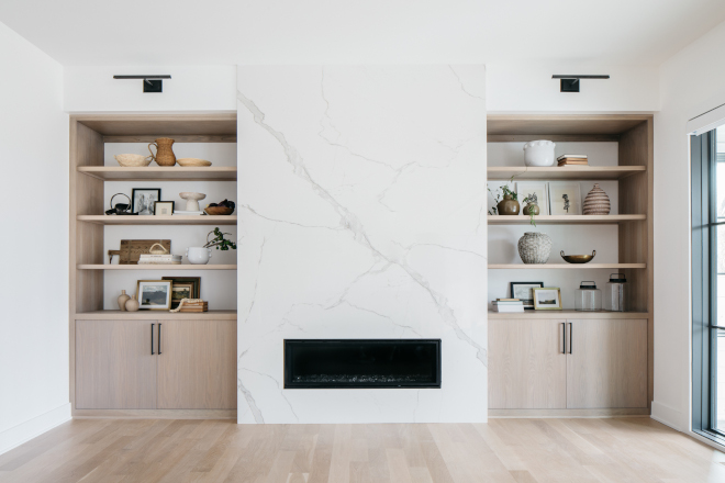 Great Room features White Oak cabinets flanking a sleek linear fireplace clad in MSI Calacatta Miraggio #fireplace #linearfireplace