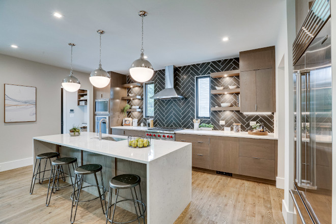 Kitchen The dramatic dark, herringbone lay of the backsplash tile welcomes both the personality and genuine warmth to this kitchen #kitchen #backsplash #blacktile