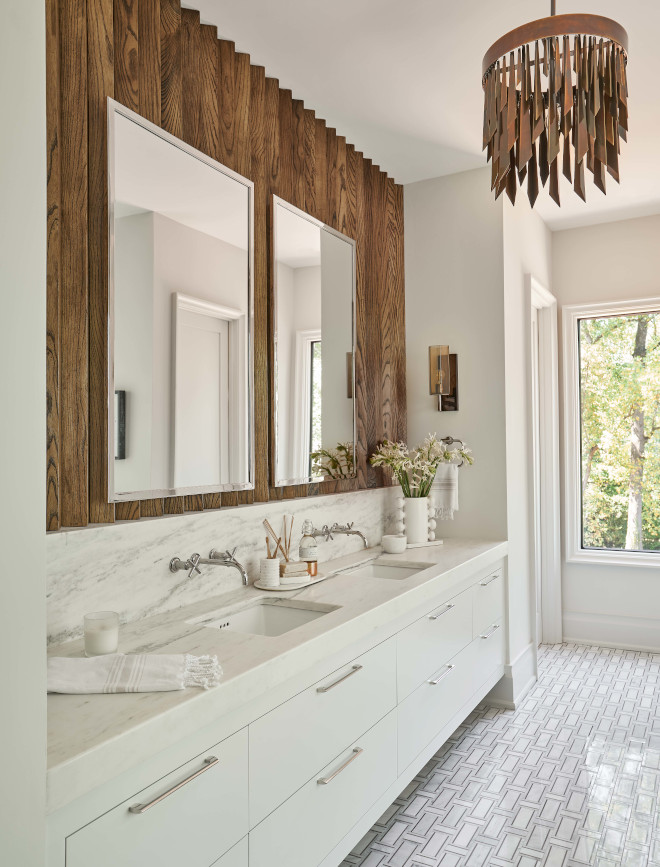 Bathroom features marble mosaic floor tiles and V-Groove wood detail as backsplash