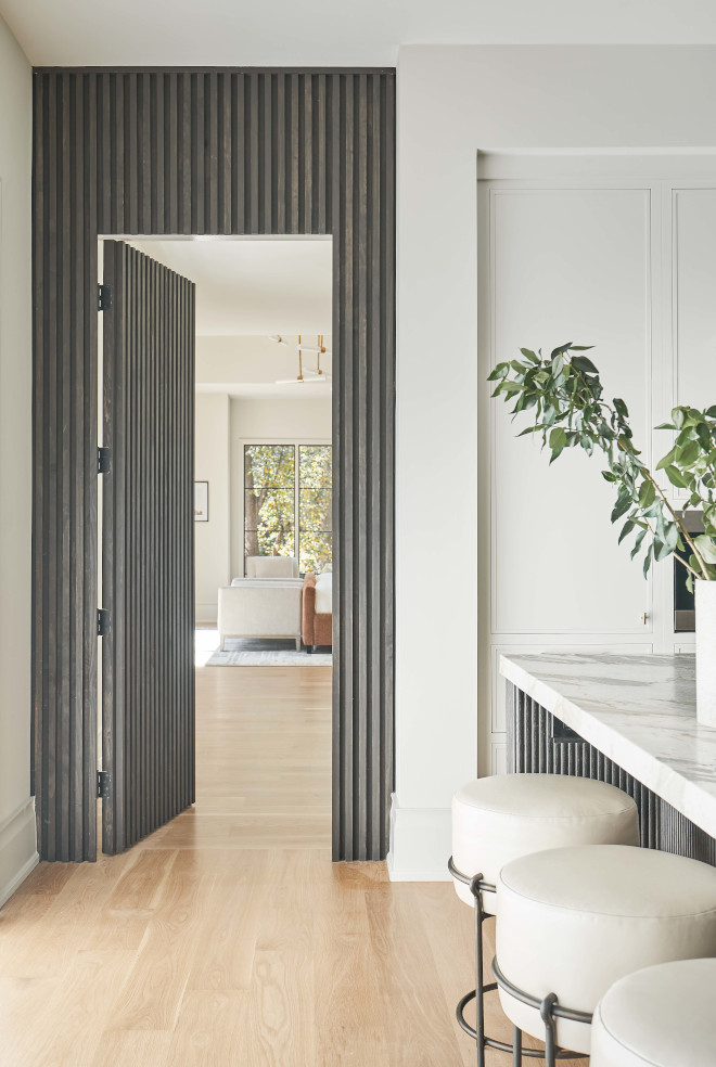 Ribbed White Oak wood paneling on the islands and on a door add personality and style to this Kitchen #kitchen #ribbed #kitchendesign