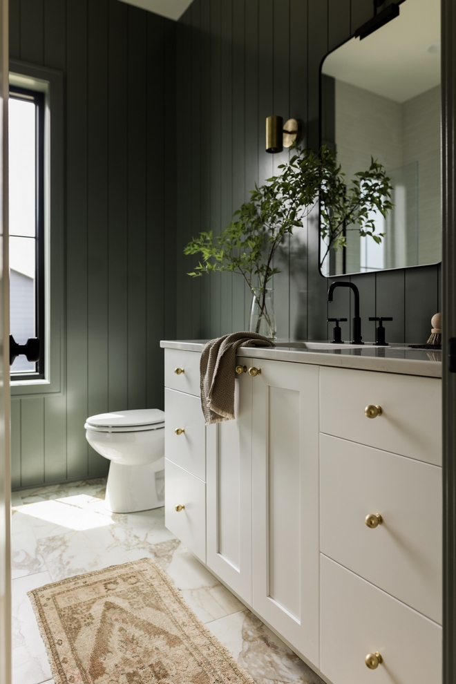 Feeling trendy yet classic this Guest Bathroom is sure to impress with its gorgeous darker-toned green walls