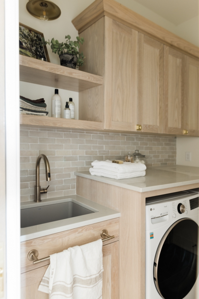 This tonal Laundry Room feels quite serene I am loving the Zellige-style backsplash along with the White Oak cabinets