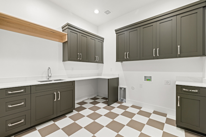 Laundry Room features Sherwin Williams Thunder Gray Cabinets with a White Oak shelf with hanging Rod