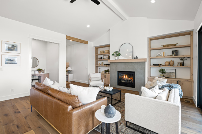 The living room features custom rustic white oak built in cabinetry on each side of the fireplace #livingroom #builtin #cabinetry