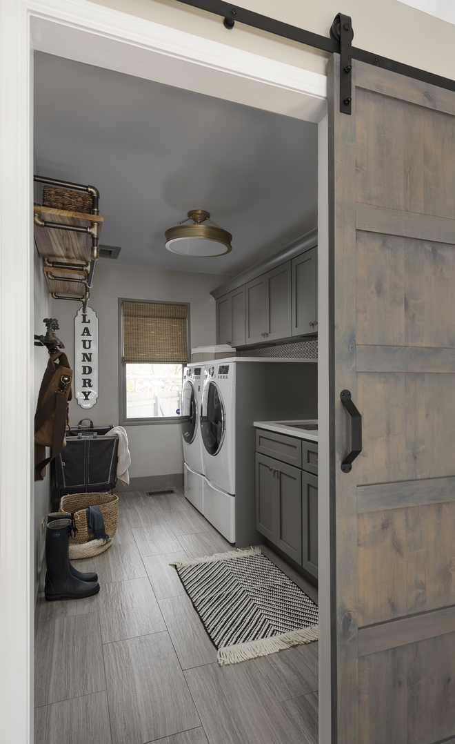  The laundry room also got a full renovation New dark grey cabinets are accentuated with practical Quartz counters and a durable porcelain tile flooring complement this dreamy space