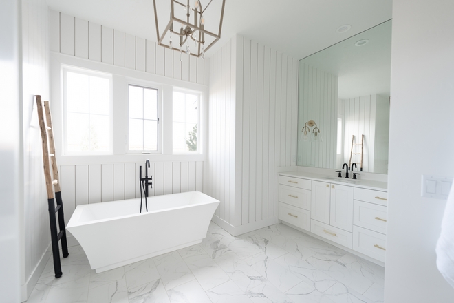This Bathroom feels very serene and feminine I love the combination of matte marble porcelain floor tiles with the white vertical shiplap on walls