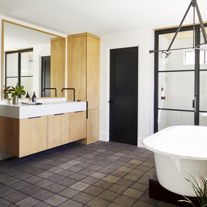 In the Primary Bathroom cement tiles give this space an unique rustic feel and beautifully contrast with the light walls and white Oak cabinetry