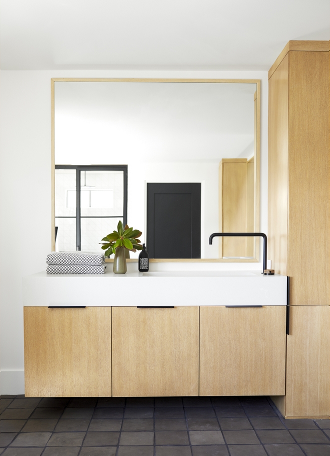 The custom vertical grain white oak vanity is sleek and gives a serene feel of this bathroom