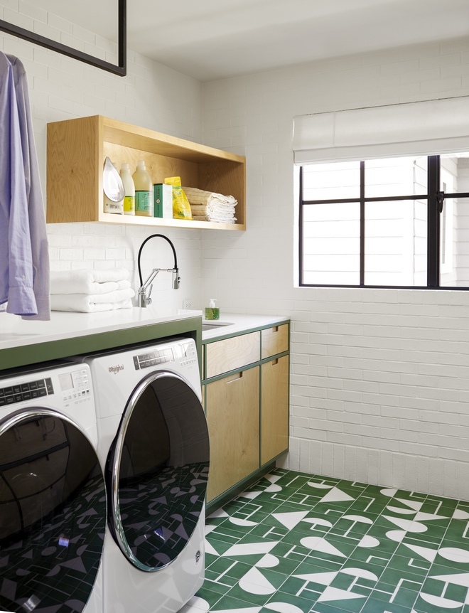How fun is this Laundry Room White Oak cabinets are accentuated with an olive green paint while white brick walls bring added texture Green and white cement floor tiles complement this happy vintage-inspired space