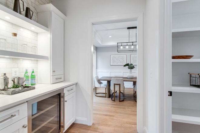 Having a butler's pantry is such a treat and this one is perfectly located between the kitchen and dining room A walk-in pantry with custom shelves is located on the right #pantry #butlerspantry #pantryideas #pantrydesign #walkinpantry
