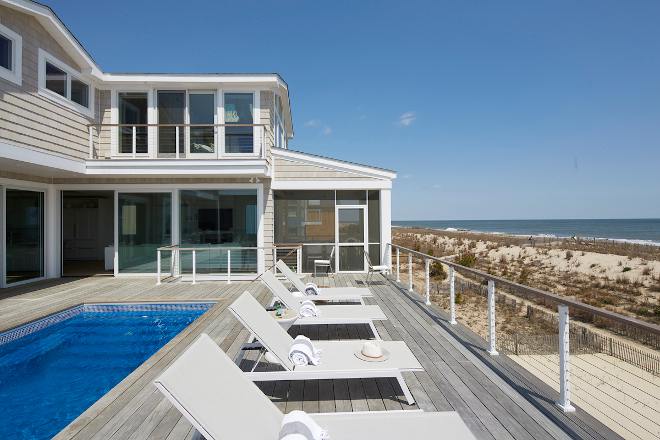 We designed this beach house entirely around the oceanfront pool and deck making sure to plan enough room for an entire row of lounge chairs #beachhouse #deck #pool #loungechairs