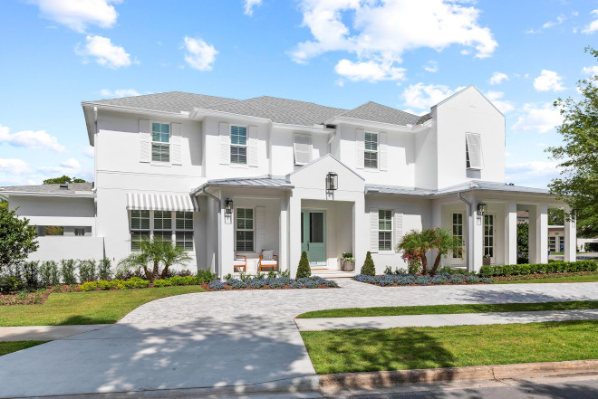 Florida House Tour A welcoming front porch showcases custom blue double entry doors which pop against the white exterior of the home #Florida #FloridaHouse #FloridaHouseTourTour #frontporch #entrydoor #whiteexterior #home